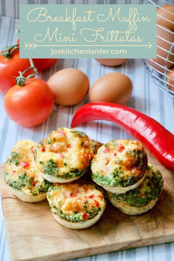 Breakfast muffin frittatas piled up on a wooden board.