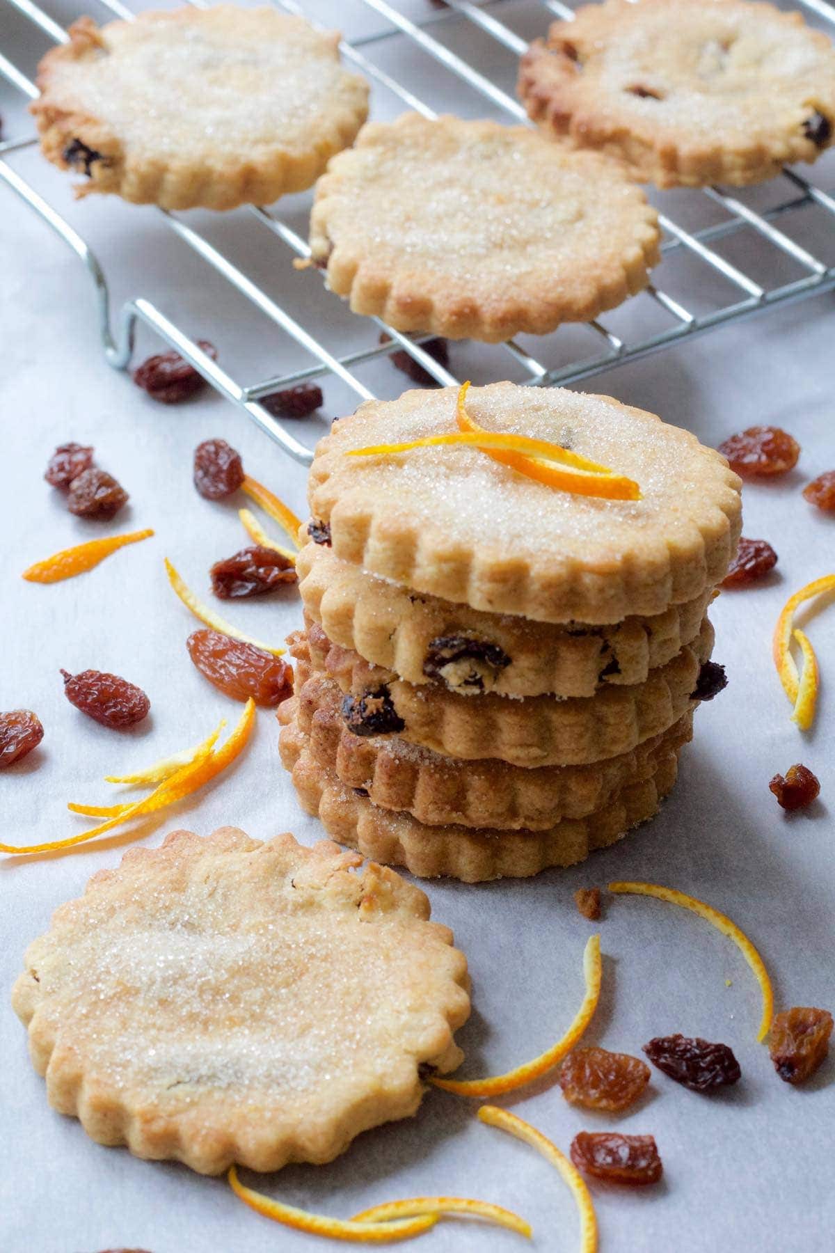 Small stack of biscuits, sultanas & orange rind.