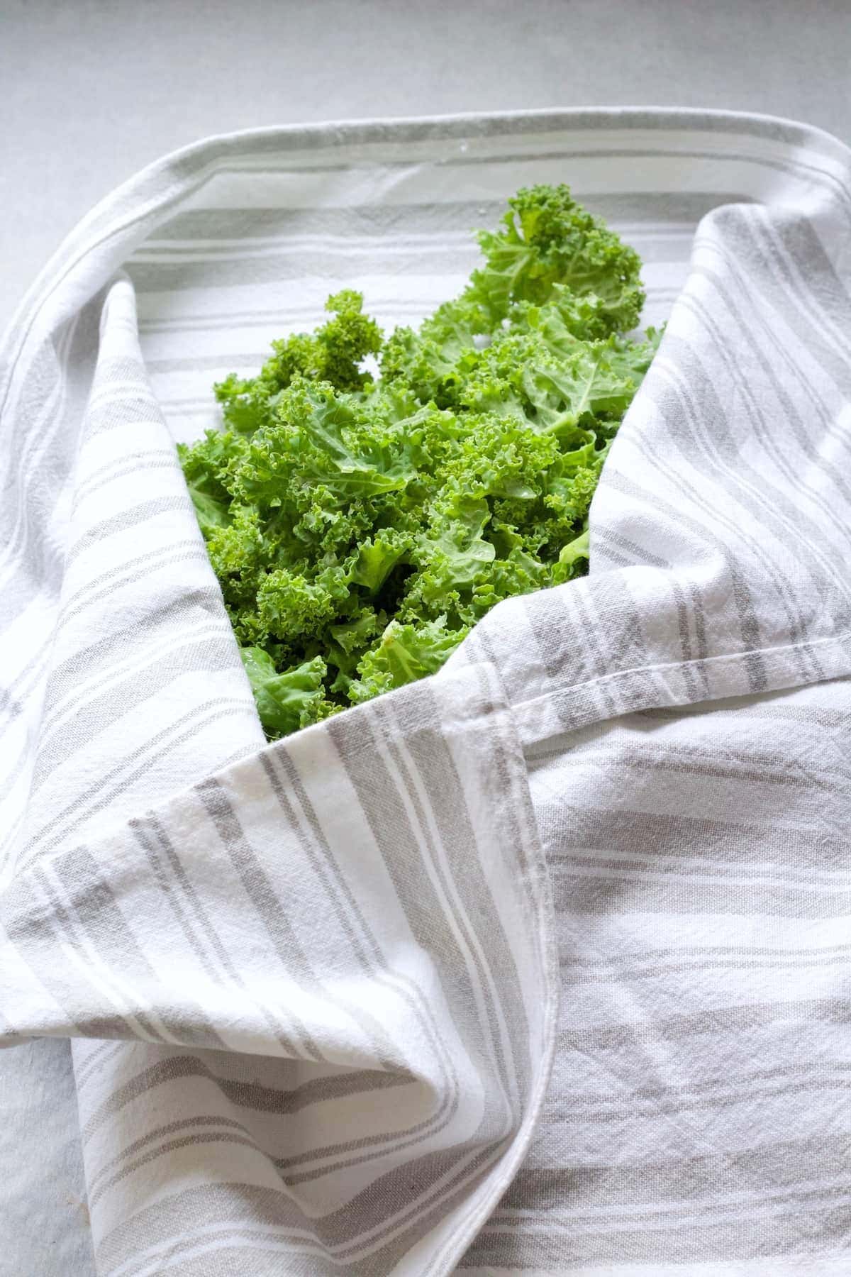 Washed greens wrapped in kitchen towel.