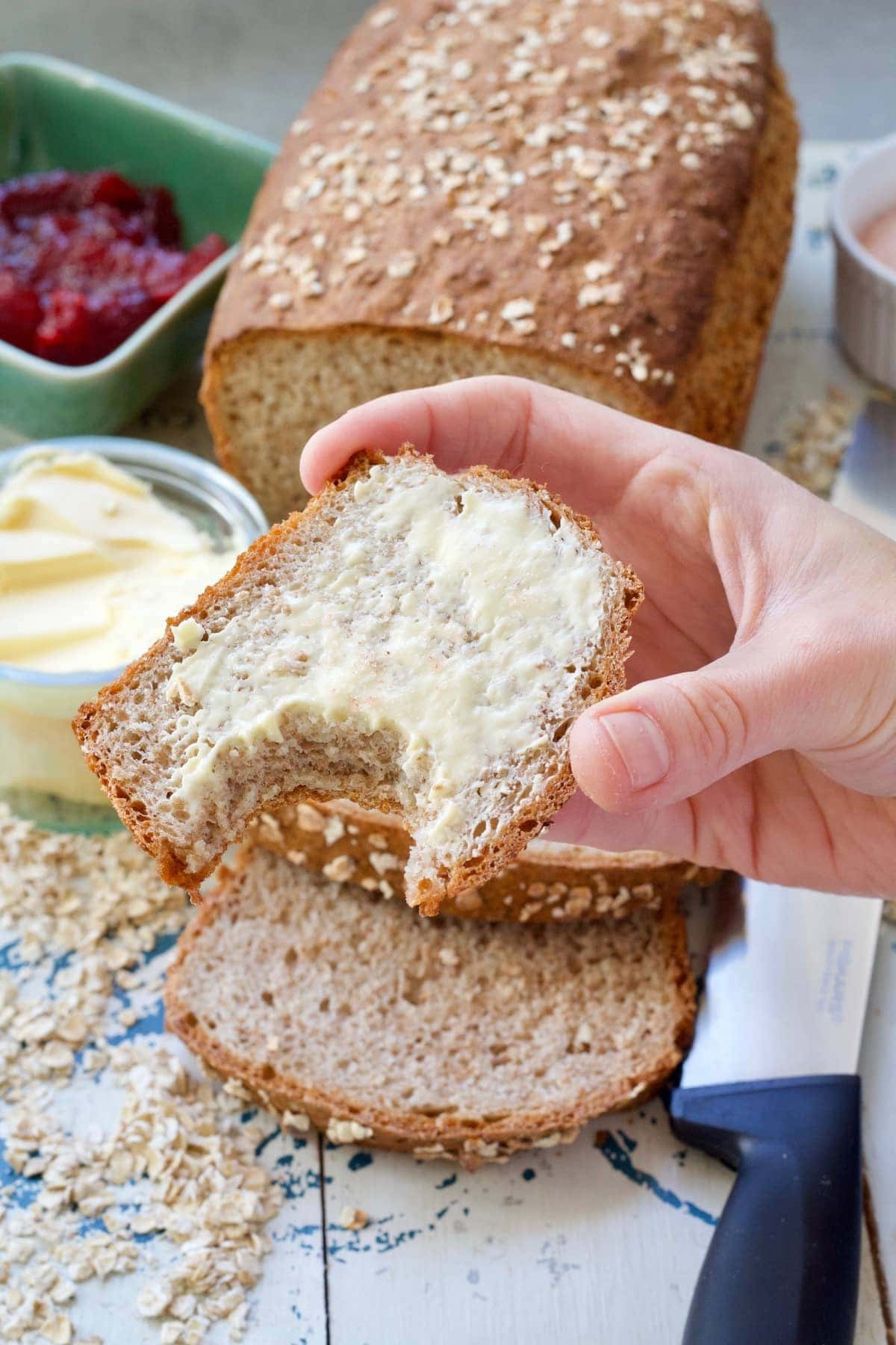 Buttered slice of bread with bite marks.