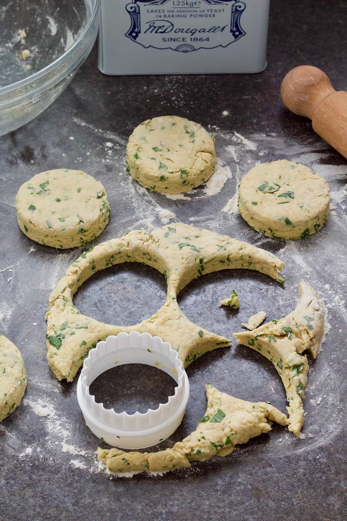 Cutting out scones with round cutter.