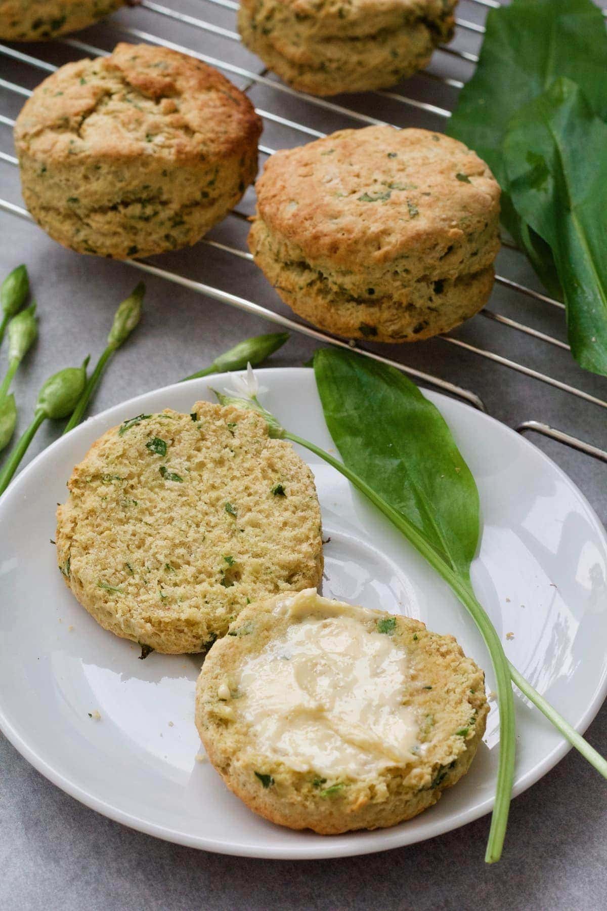 Two scone halves on a plate, one buttered.