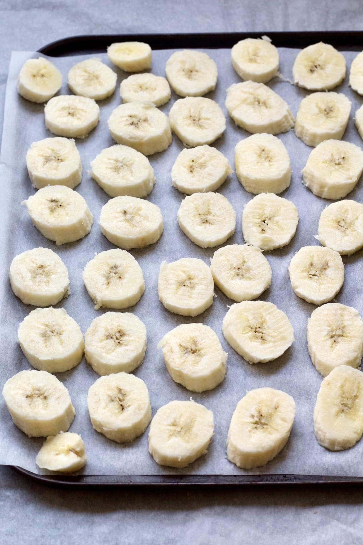 Banana slices on a baking tray.