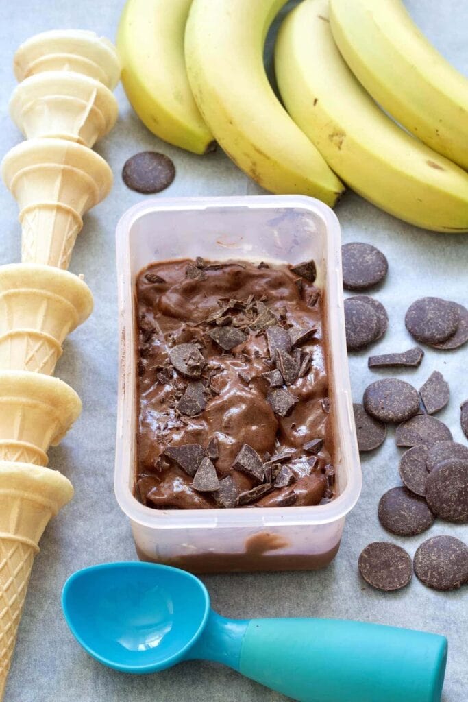 Chocolate ice cream in a box topped with more chocolate.