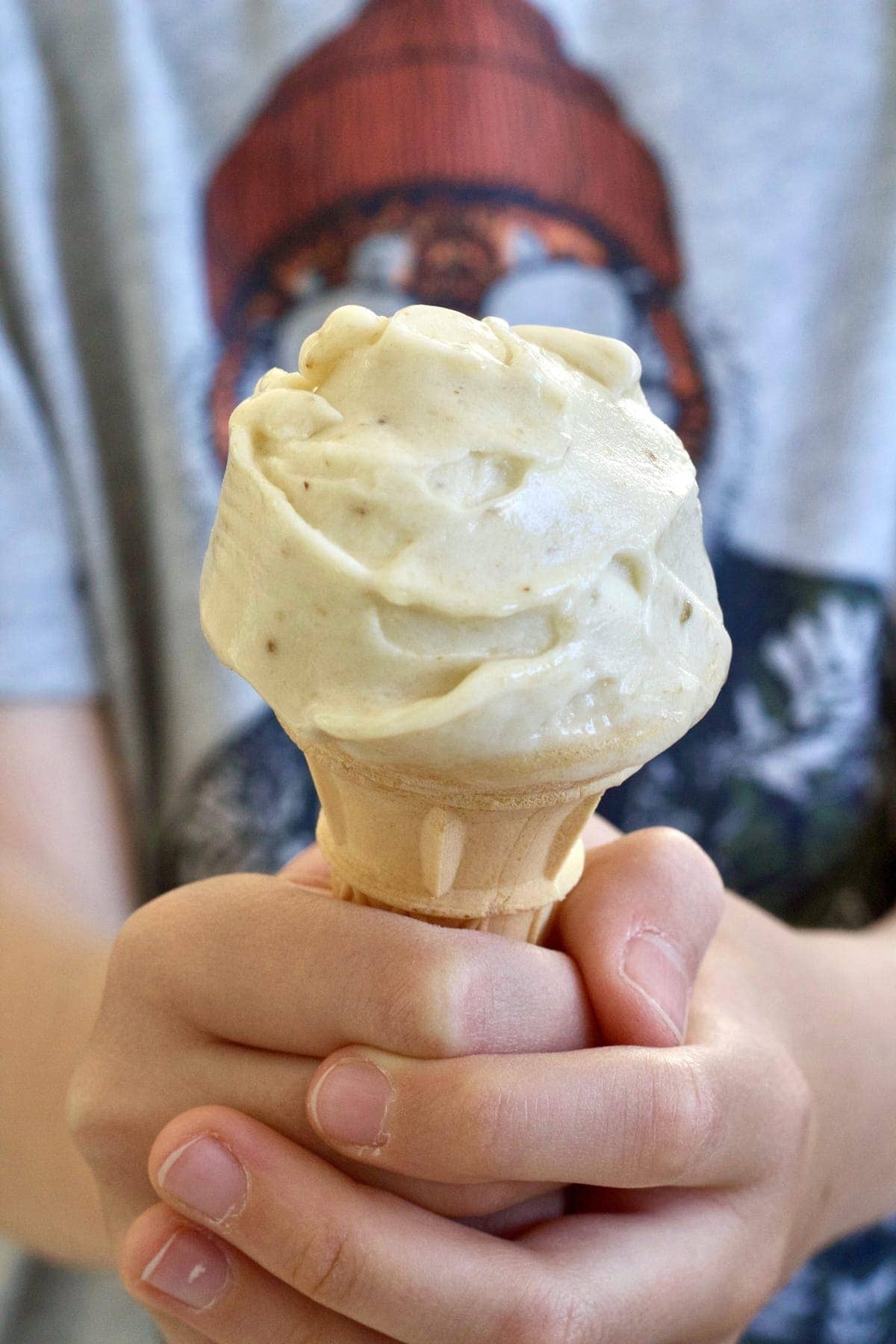 Hand holding ice cream cone.