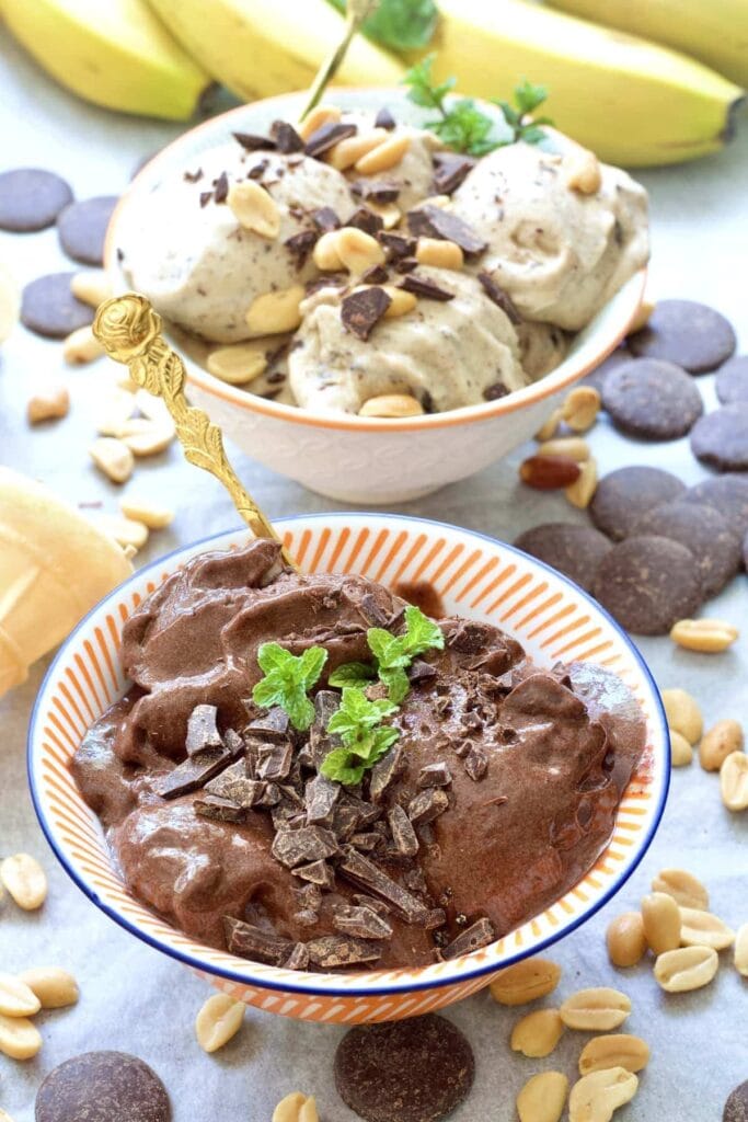 Two bowls of ice cream with garnishes.