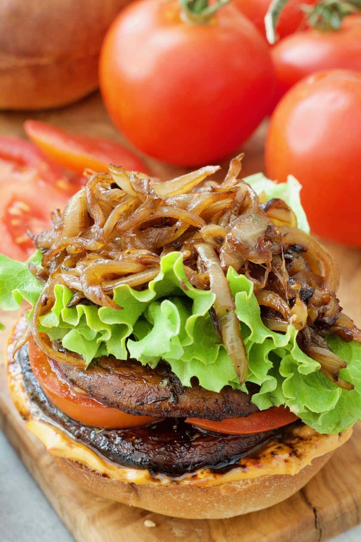 Close up of a burger with lots of caramelised onions on top and no bun.