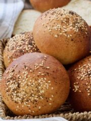 Bread rolls in the basket with sesame & poppy seeds on top.