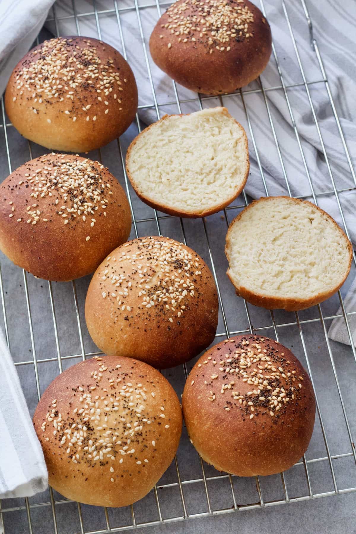 Rolls on the cooling rack, one cut in half - top view.