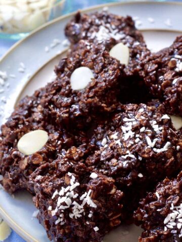 Chocolate Oatmeal cookies piled up on a plate.