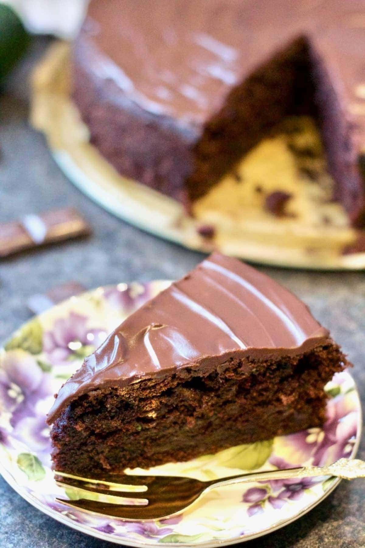 Slice of Chocolate Courgette (Zucchini) Cake on a plate. 