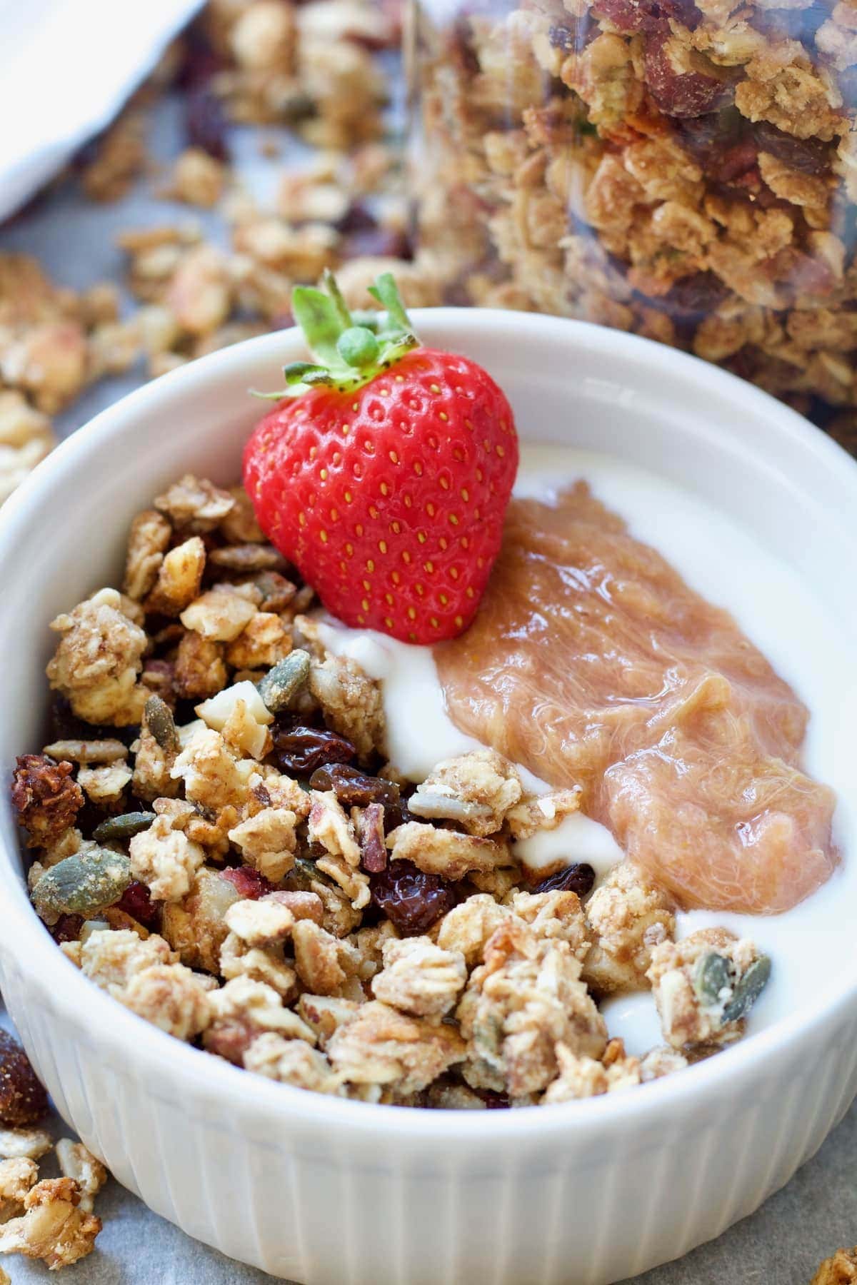 Granola with yogurt, stewed rhubarb & a strawberry.