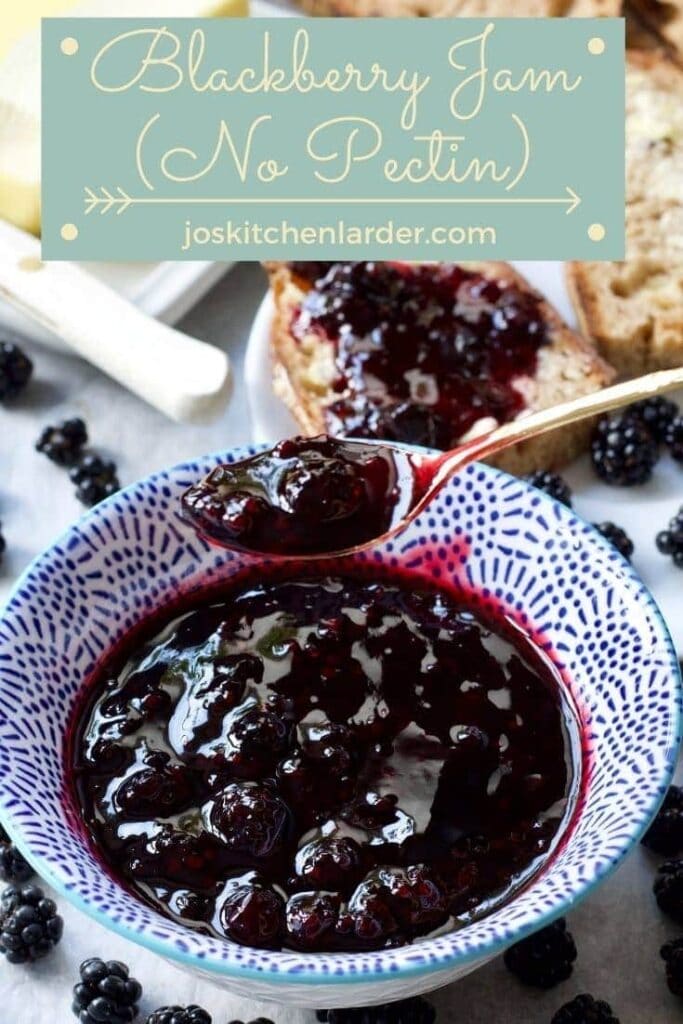 Spoonful of blackberry jam over a bowl filled with jam.