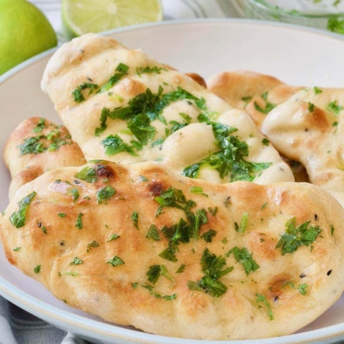 Close up of cooked easy naan bread with coriander and garlic butter.