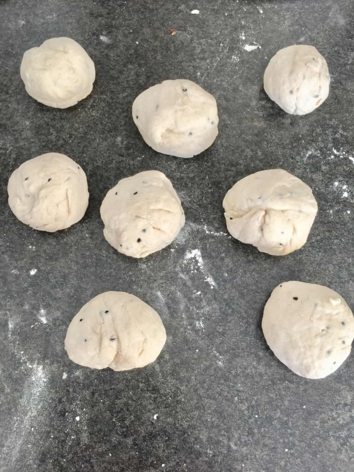 8 dough balls on the counter.