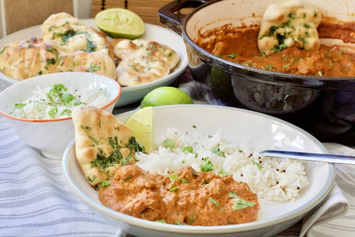 Curry spread with bowl full of easy naan bread in the background.