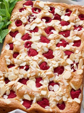 Whole raspberry cake with fresh mint & flaked almonds.