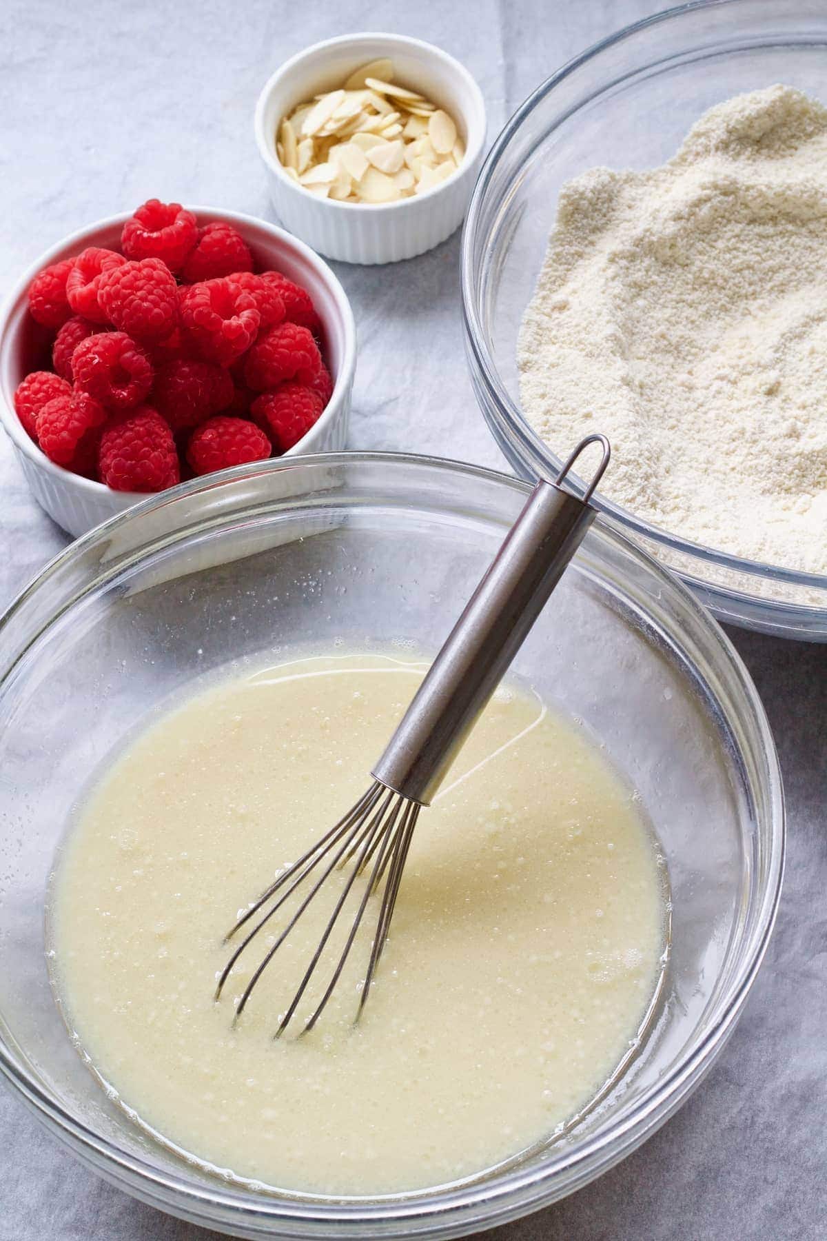 Dry and wet ingredients, fresh raspberries & flaked almonds.