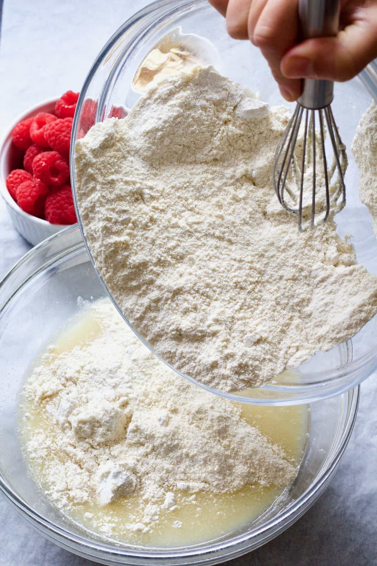 Dry ingredients being poured into wet ones.