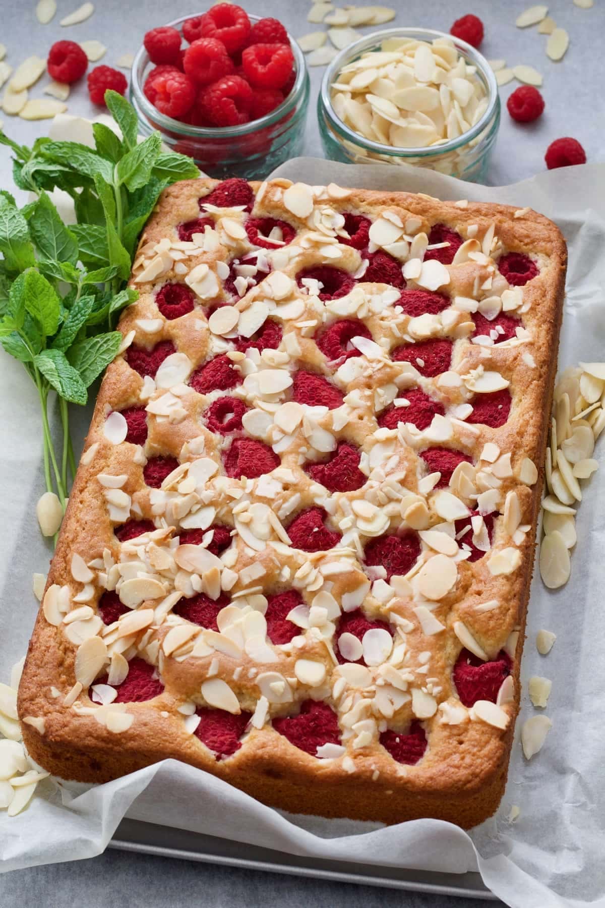 Whole raspberry cake with mint, fresh raspberries & flaked almonds.