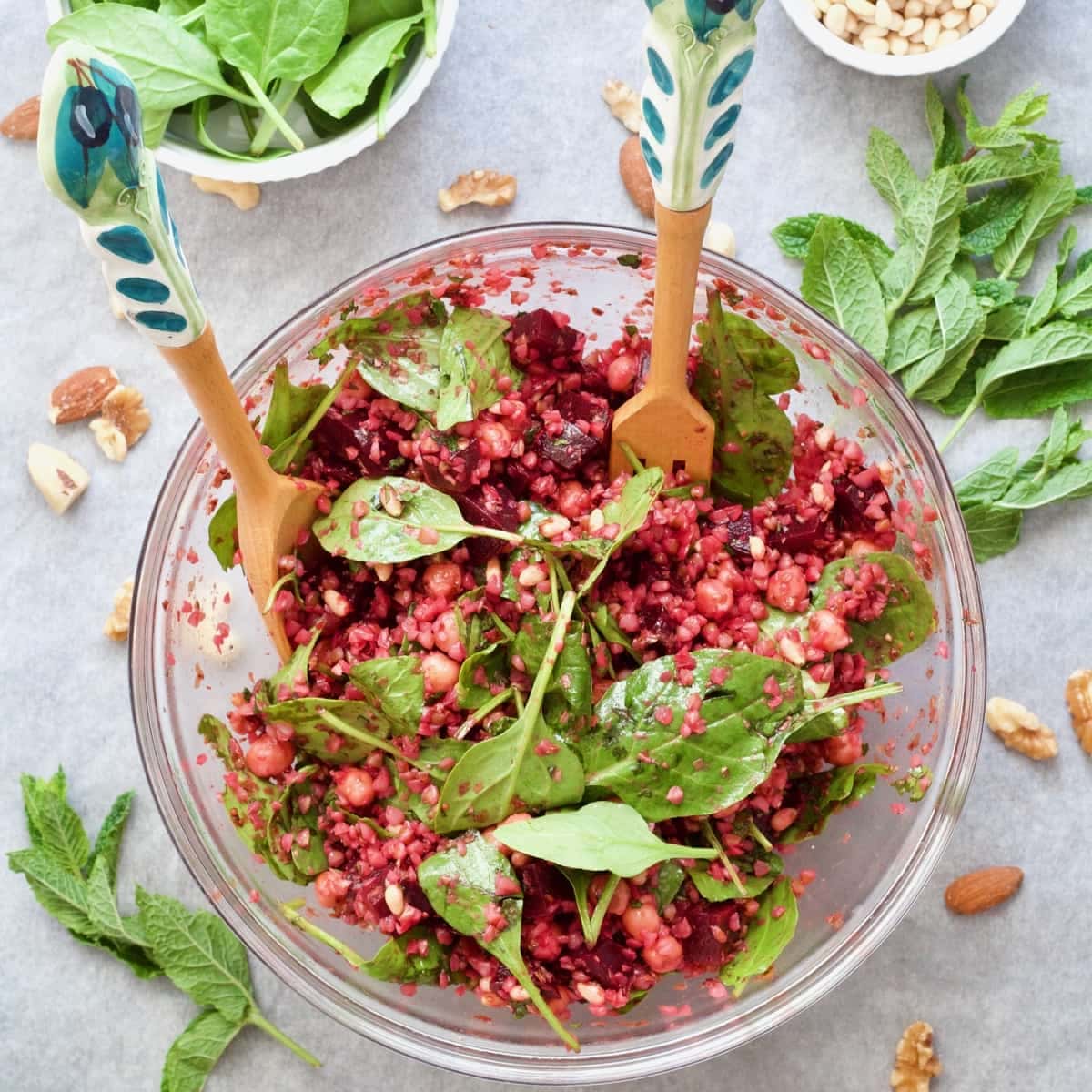 Buckwheat salad presented in a bowl with decorative salad servers.