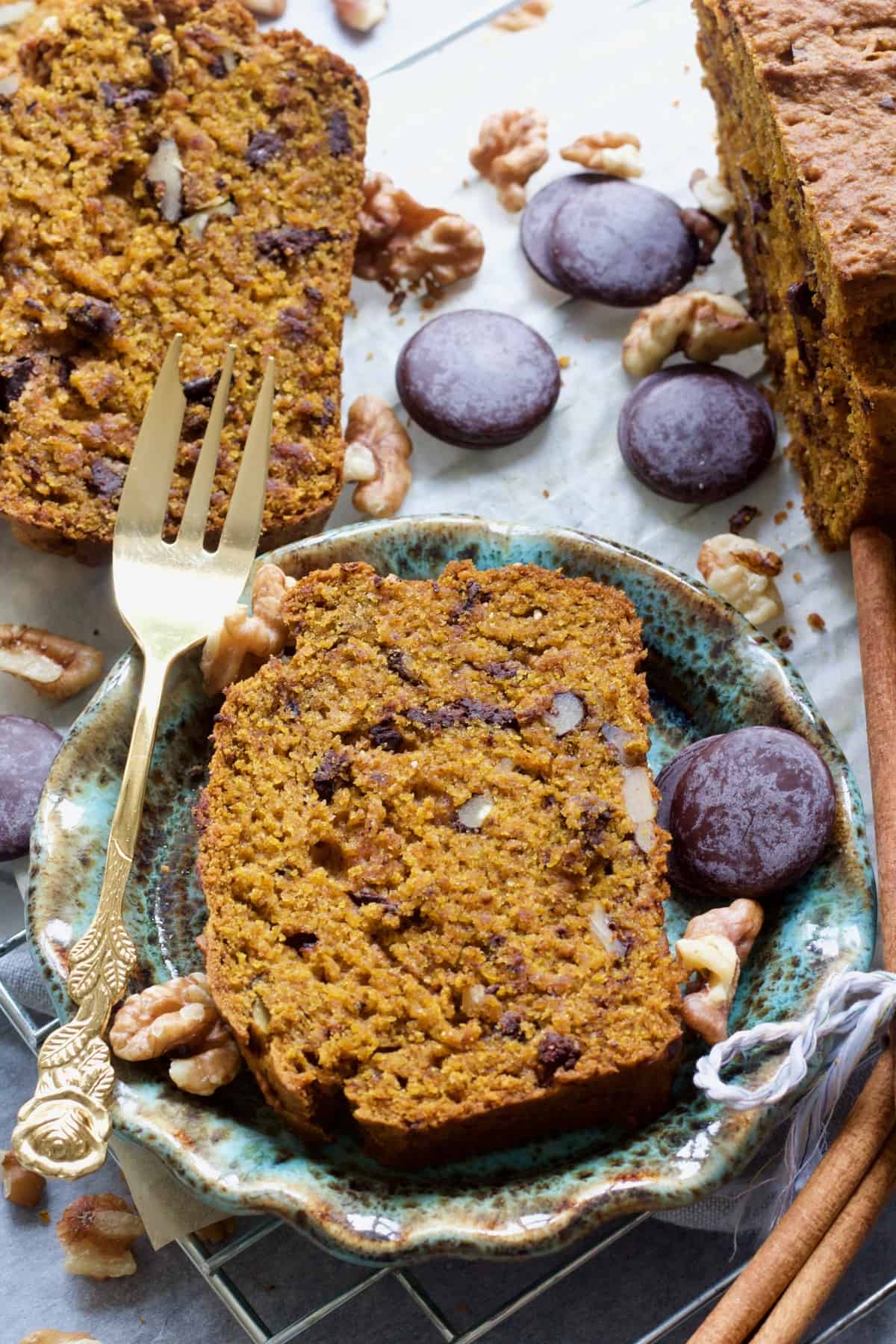 Slice of pumpkin banana bread on a small plate with a fork.