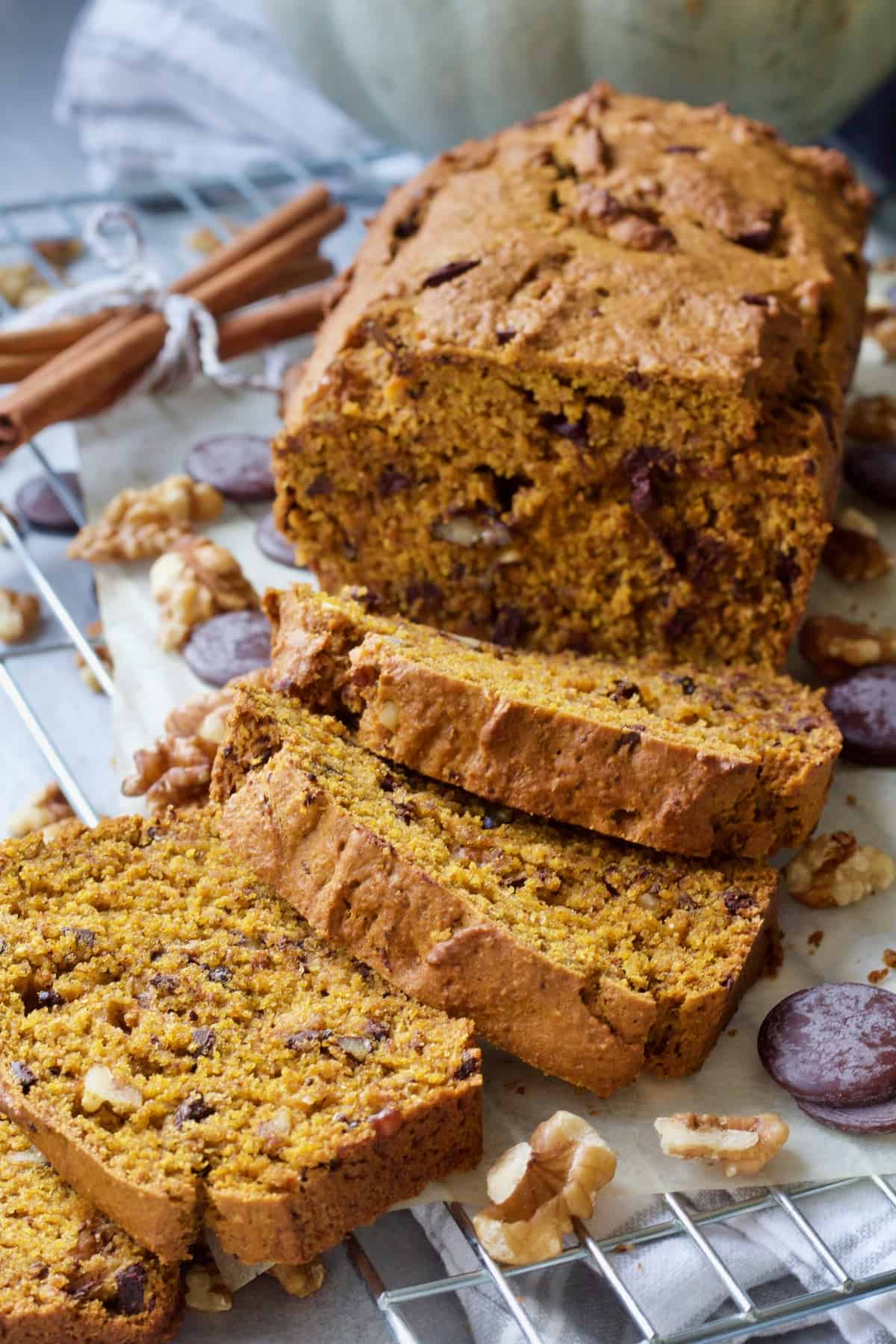 Pumpkin banana bread loaf with three slices cut.