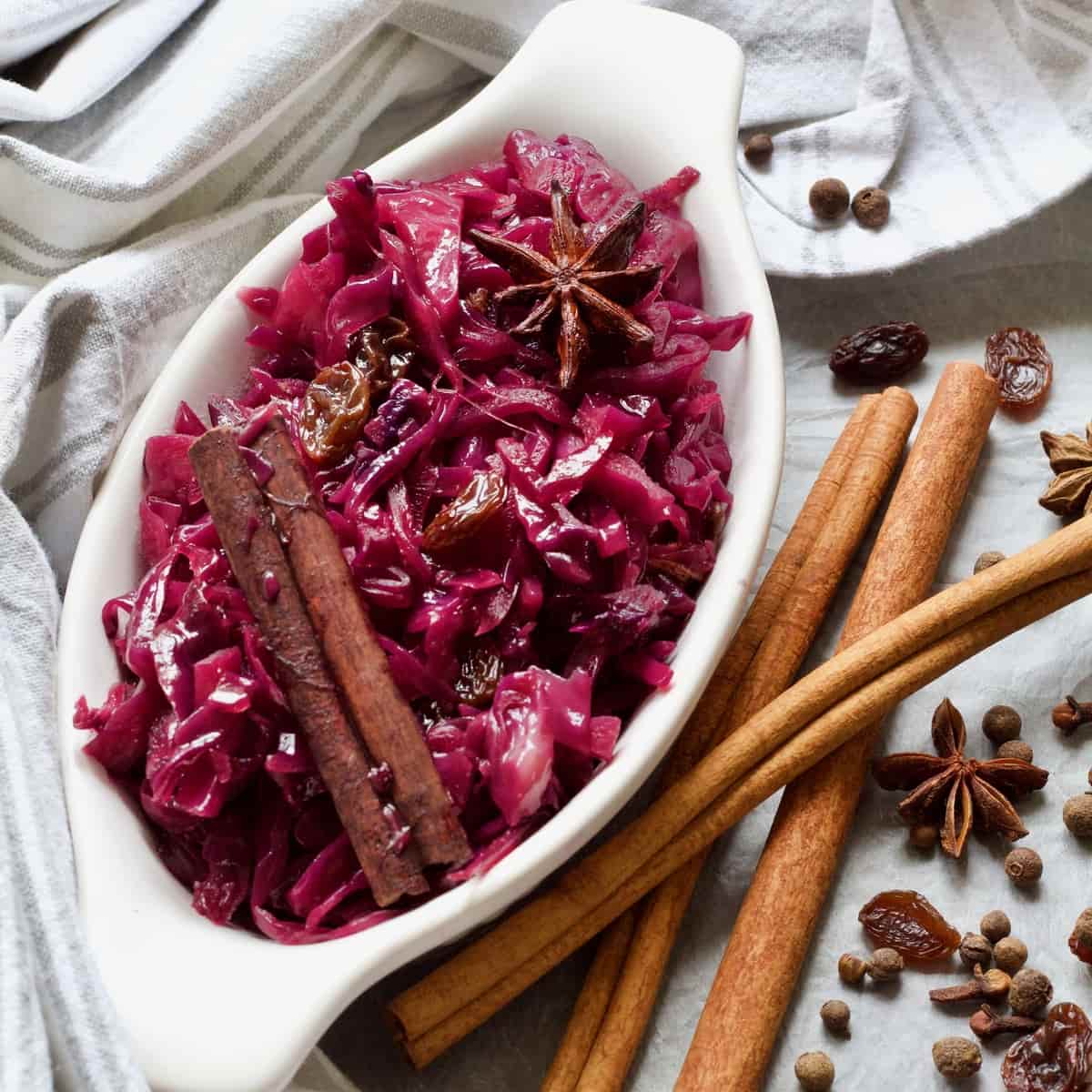 Oval dish with red braised cabbage, raisins and spices.