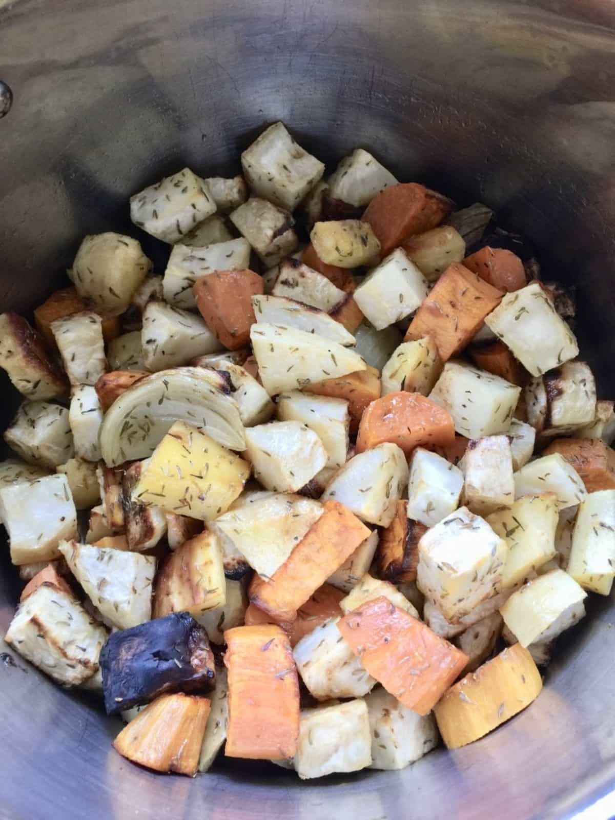 Roasted vegetable chunks in a pot.