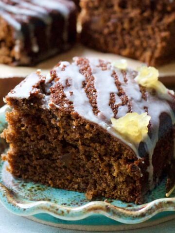 Close up of gingerbread cake square on a plate.