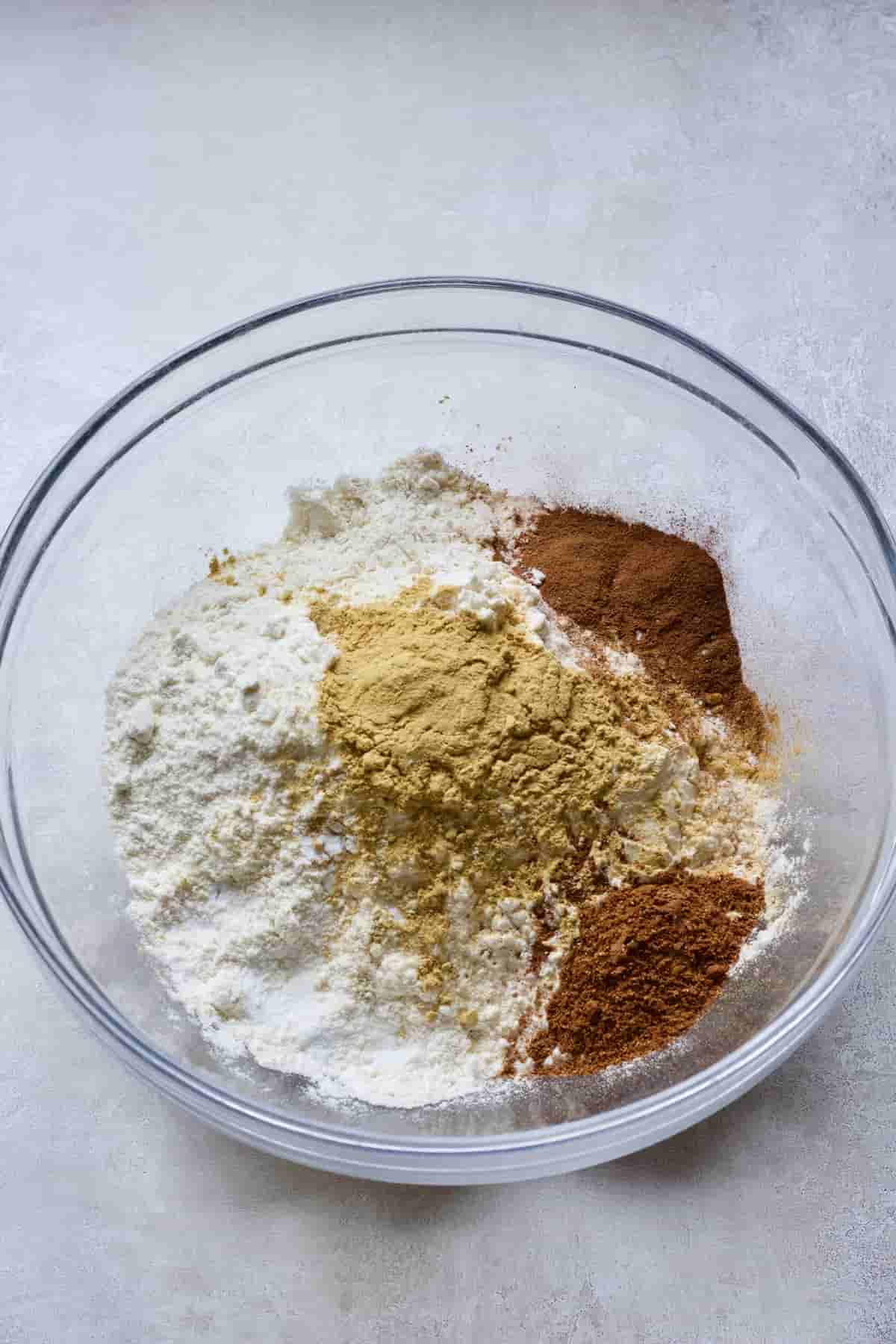 Flour and spices in a glass bowl.