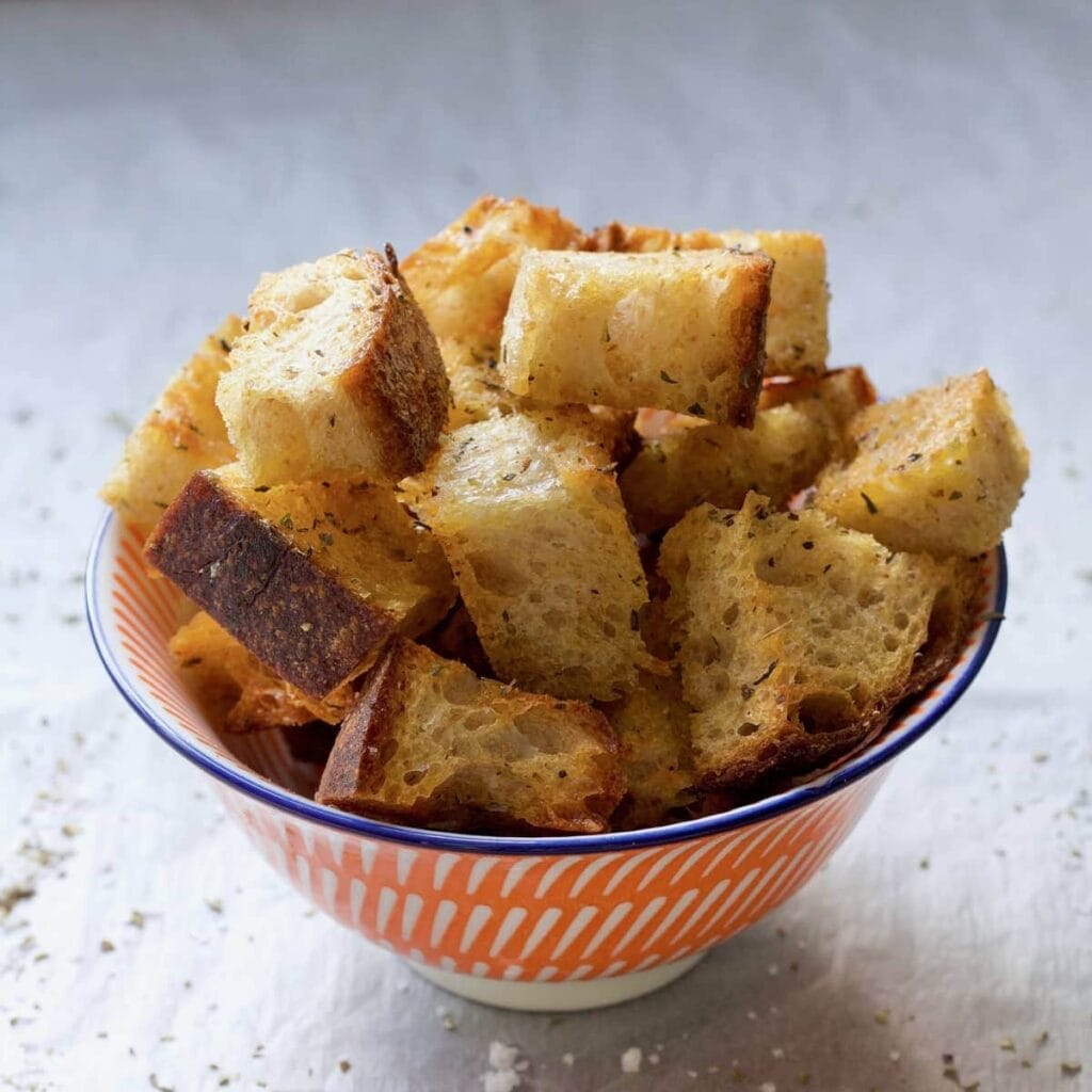 Small bowl full of croutons.