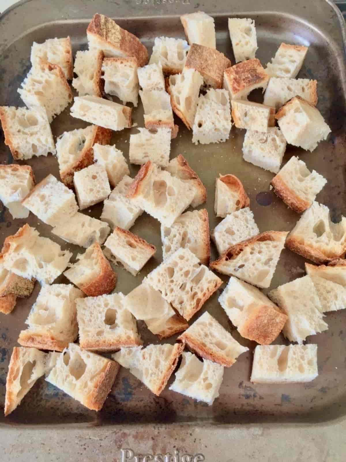 Plain chunks of bread on a baking tray.