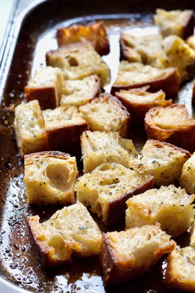 Close up of croutons on a baking tray.