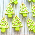 Christmas tree shaped cookies on a cooling rack.