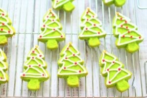 Christmas tree shaped cookies on a cooling rack.