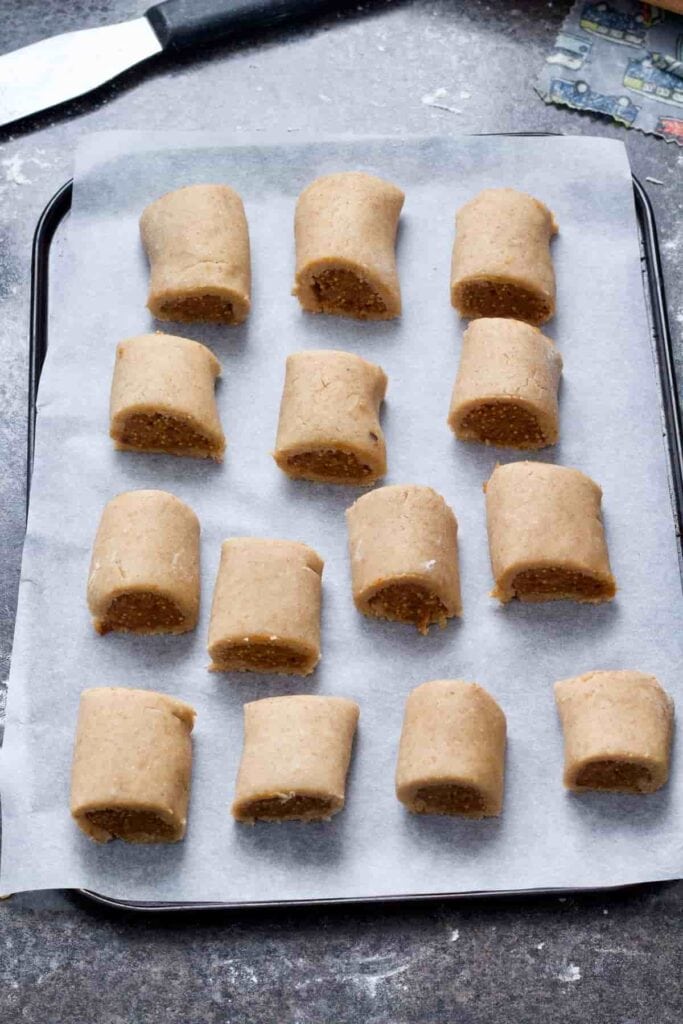 Unbaked fig rolls on a tray.