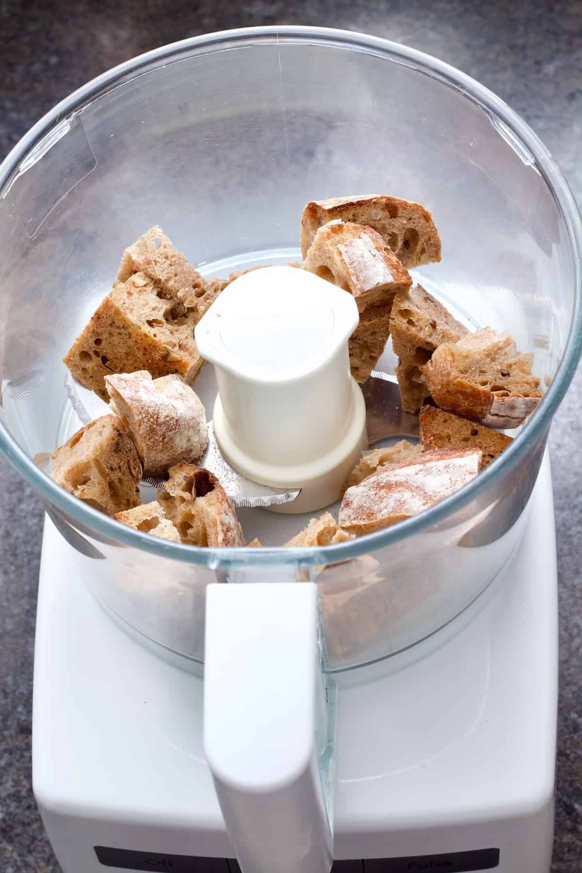Cubes of bread in a food processor.