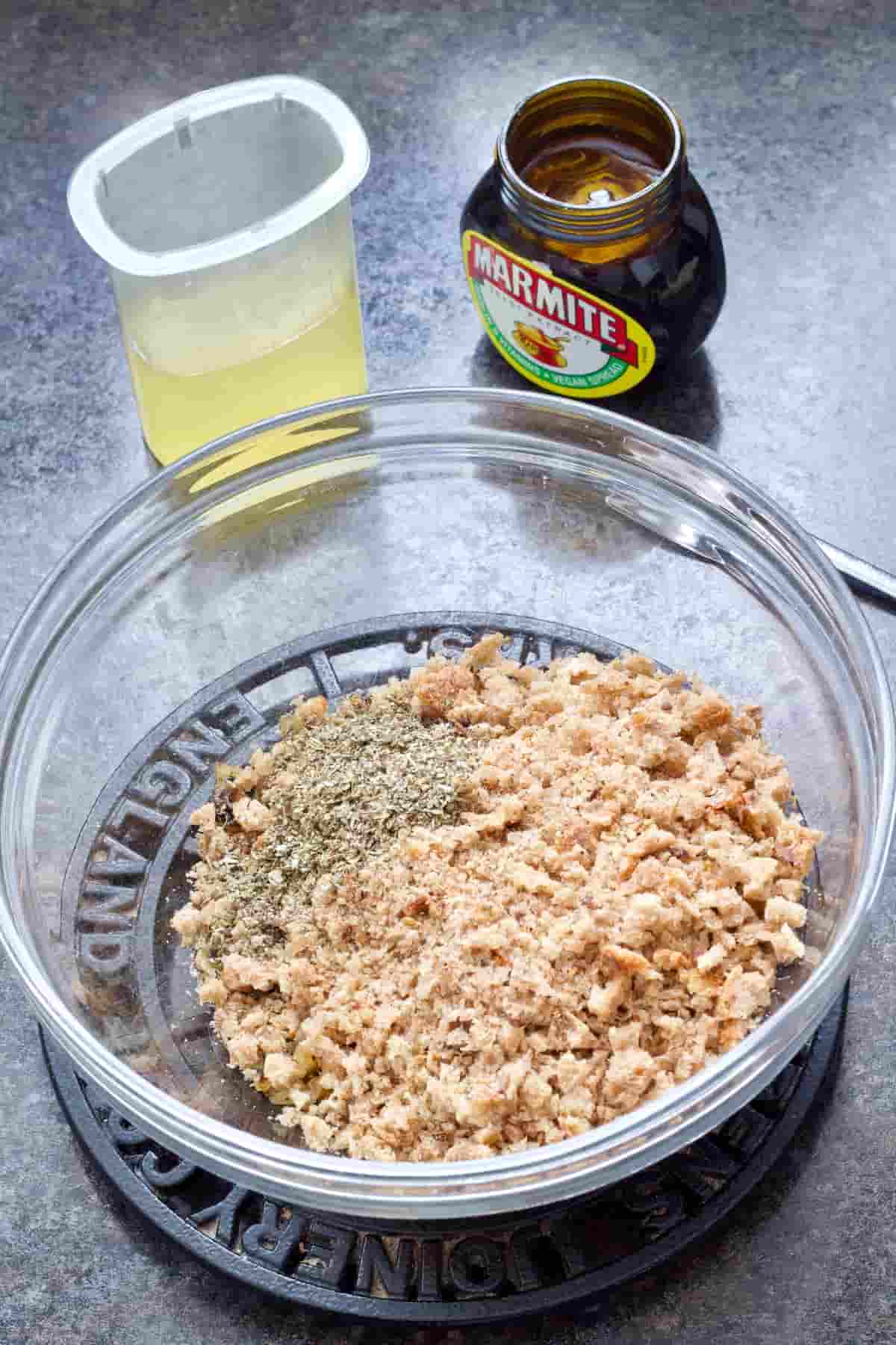 Bowl with breadcrumbs & sage, marmite jar & cup with stock.