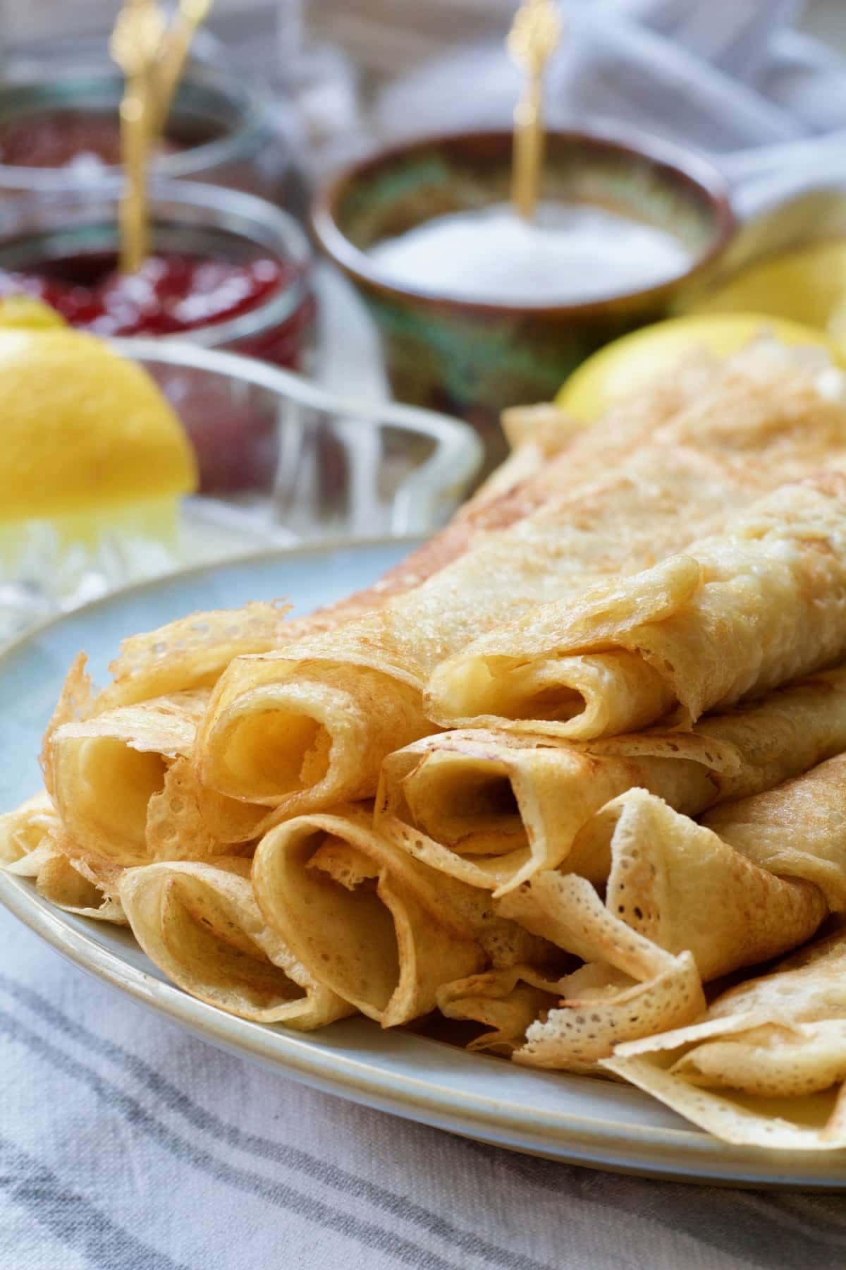 Close up of rolled vegan crepes on a plate.