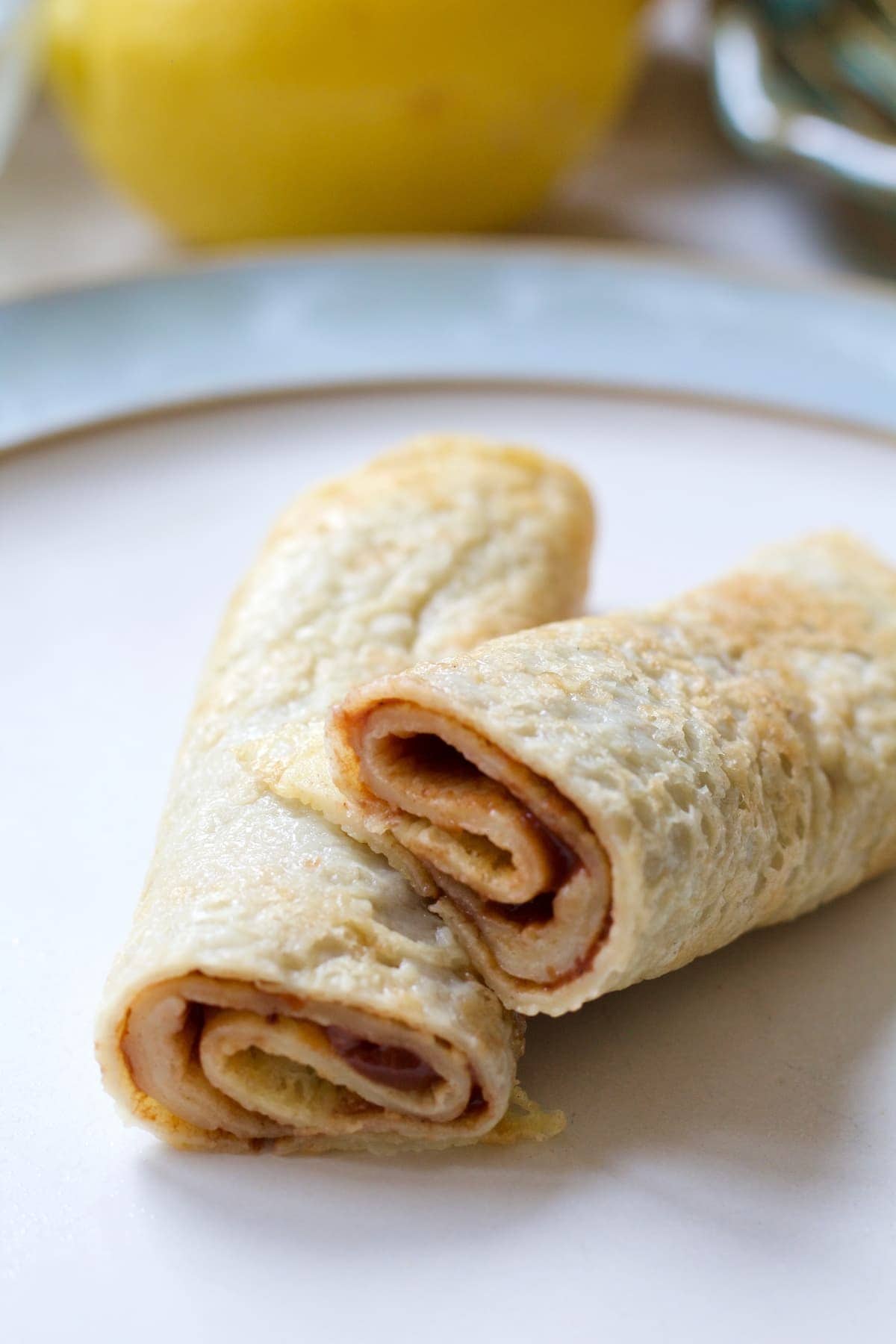Close up of rolled pancake cut in half.