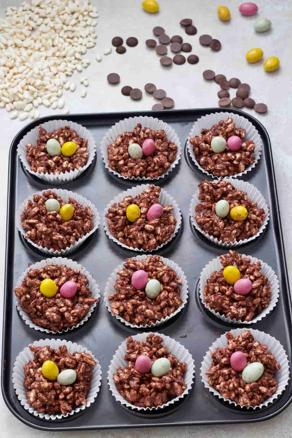 Chocolate nests in a tin topped with Mini Eggs.