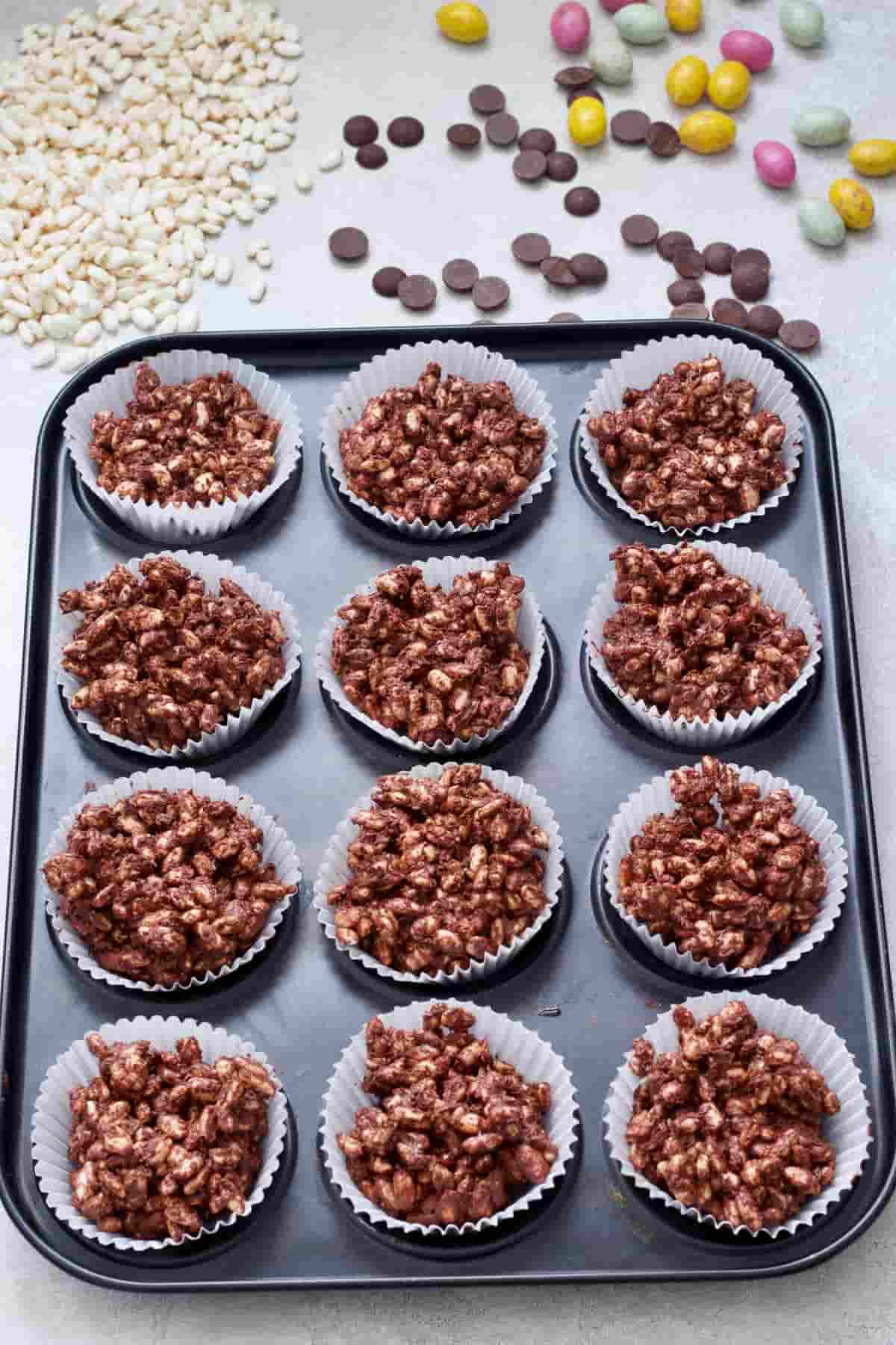 Tray filled with chocolate nests in cupcake cases.