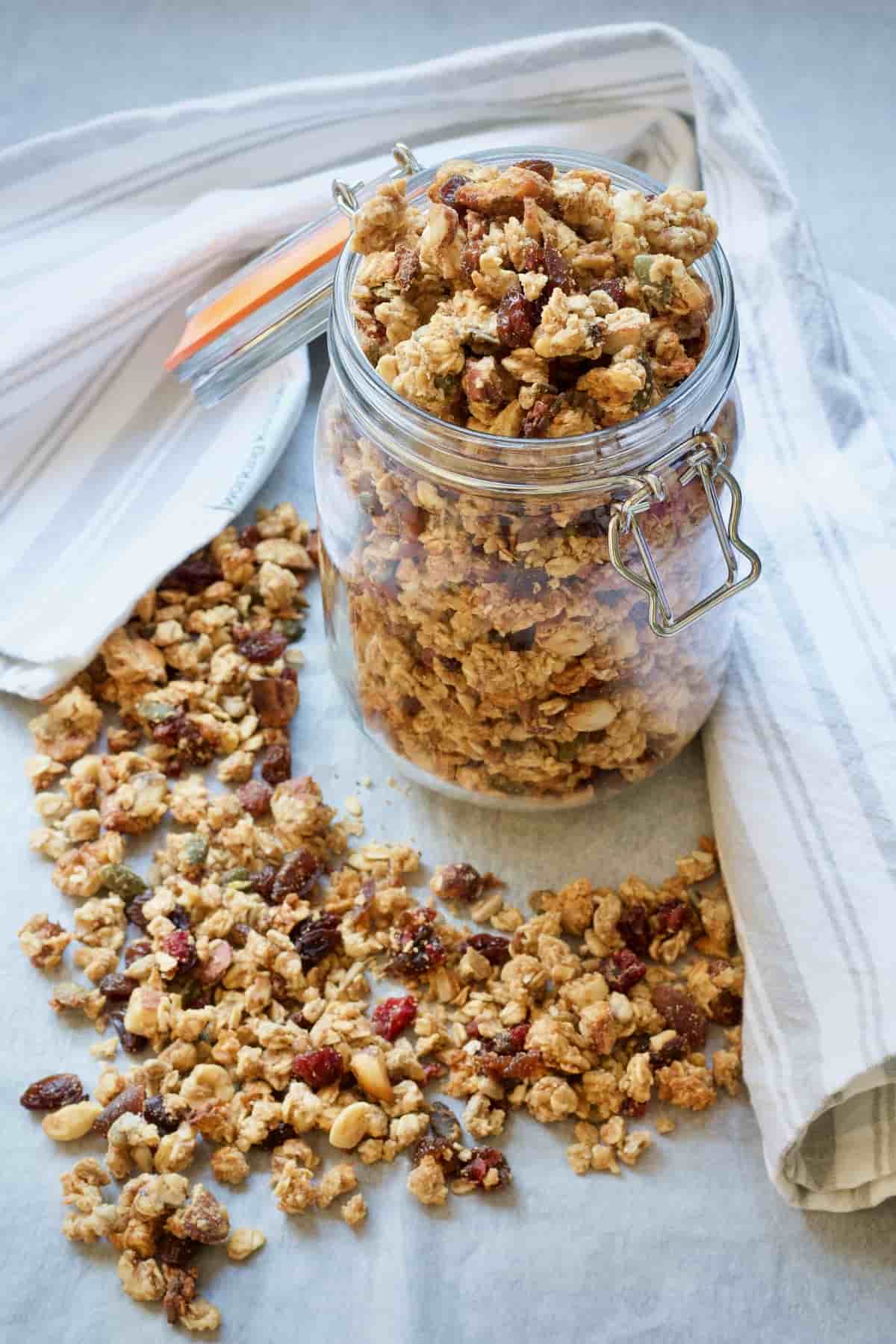 Overflowing jar full of homemade granola.