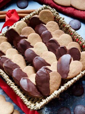 Chocolate covered cinnamon cookies in a basket.