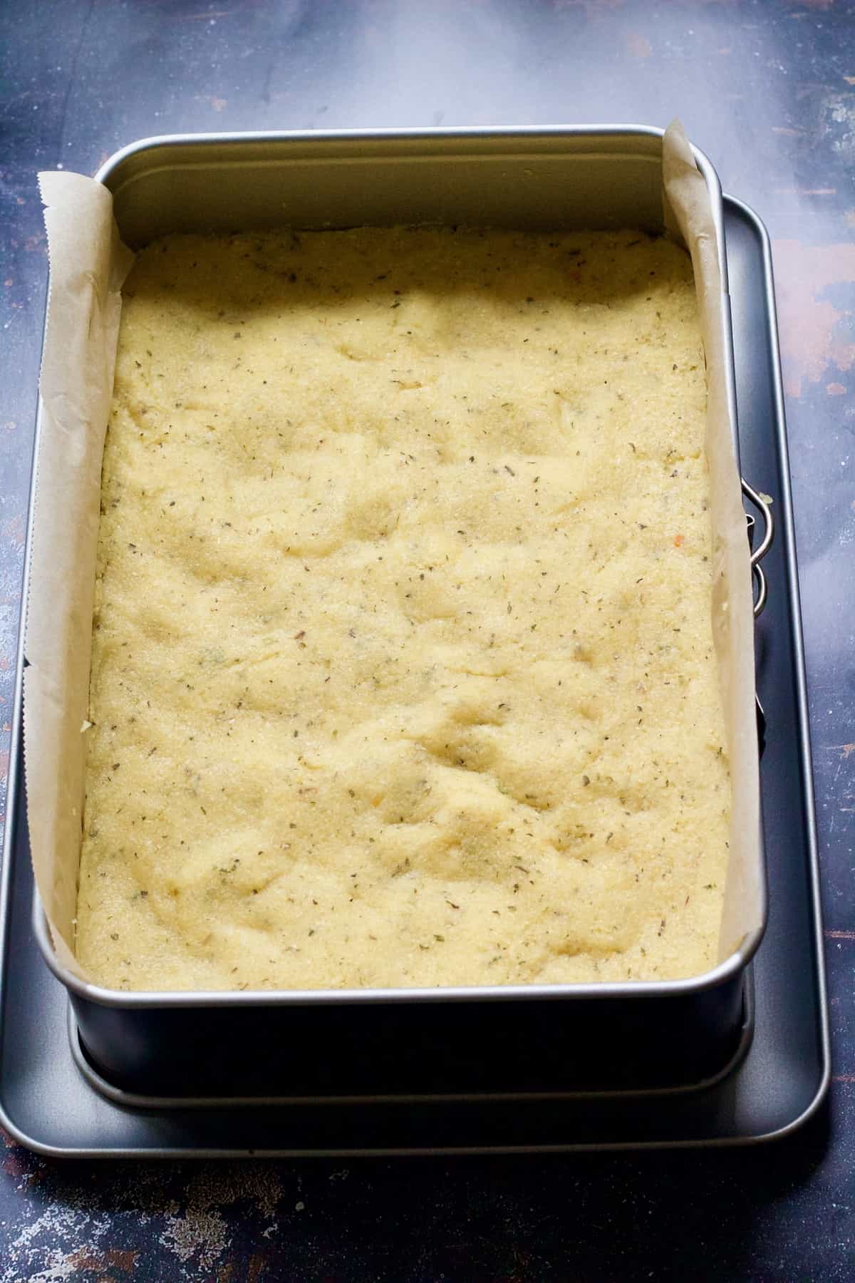 Polenta setting in a baking dish.