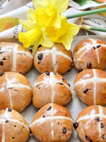 Hot cross buns with daffodils at the top.