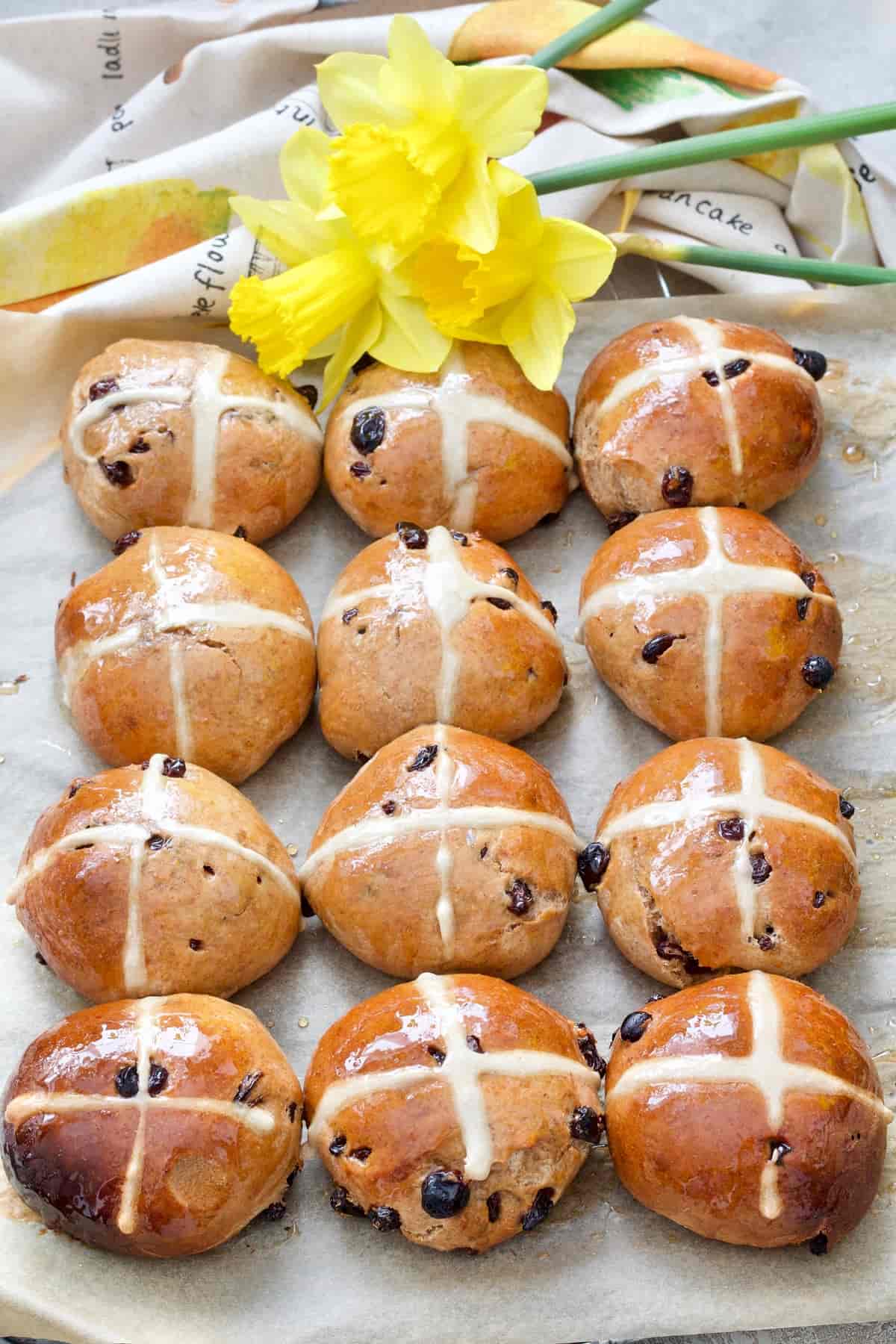 Hot cross buns with daffodils at the top.