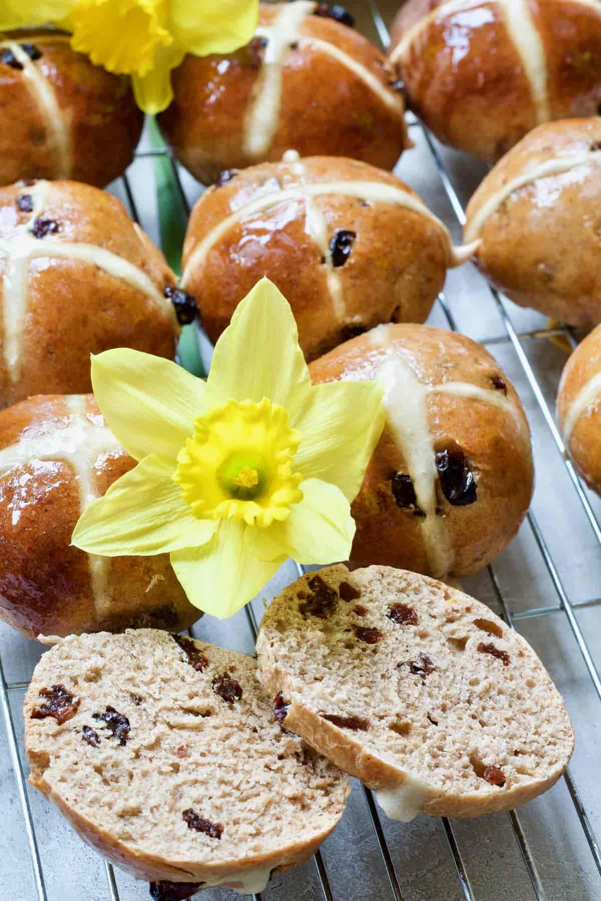 Bun cut open with daffodil next to it.