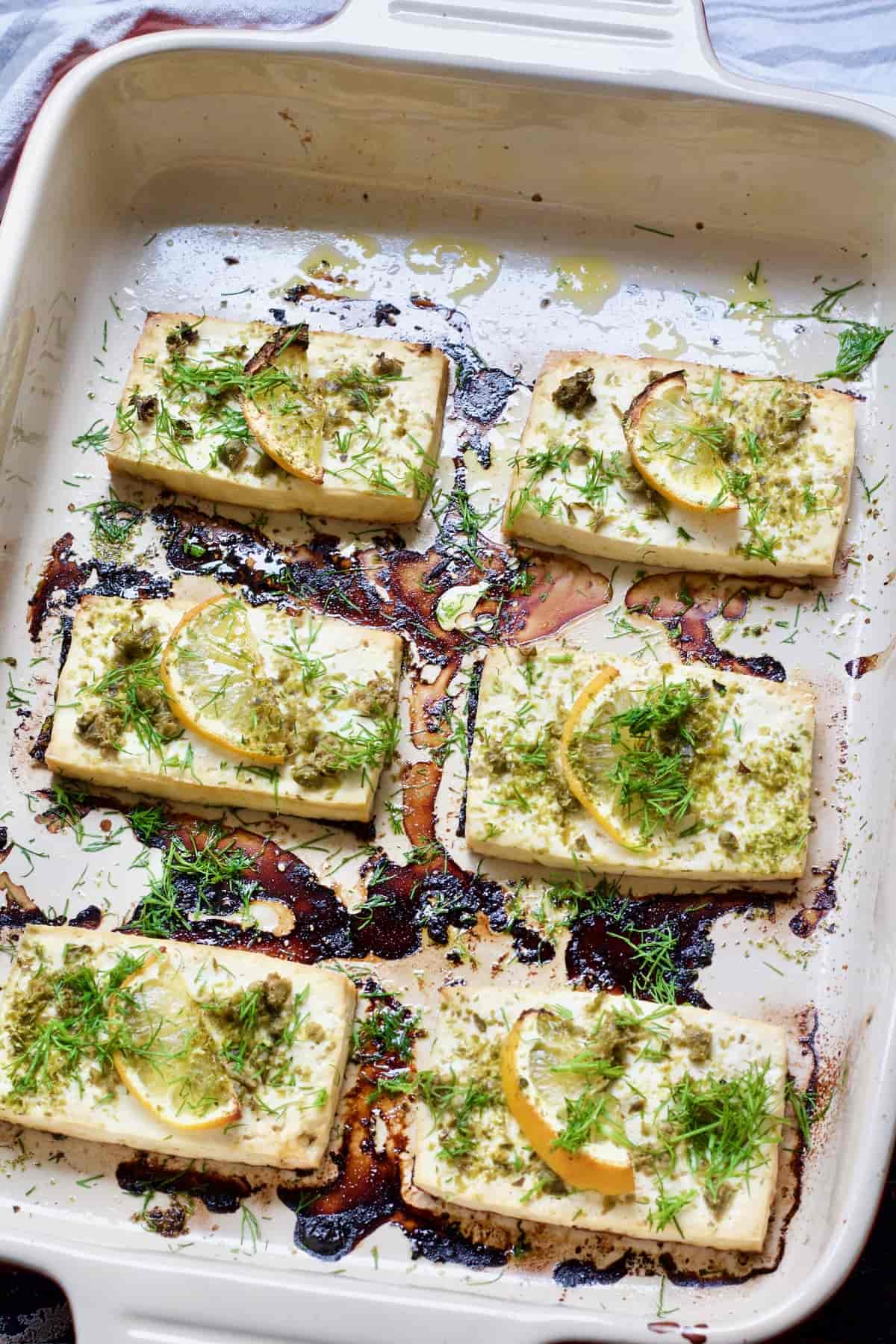 Baking dish with 6 slices of baked tofu fish.